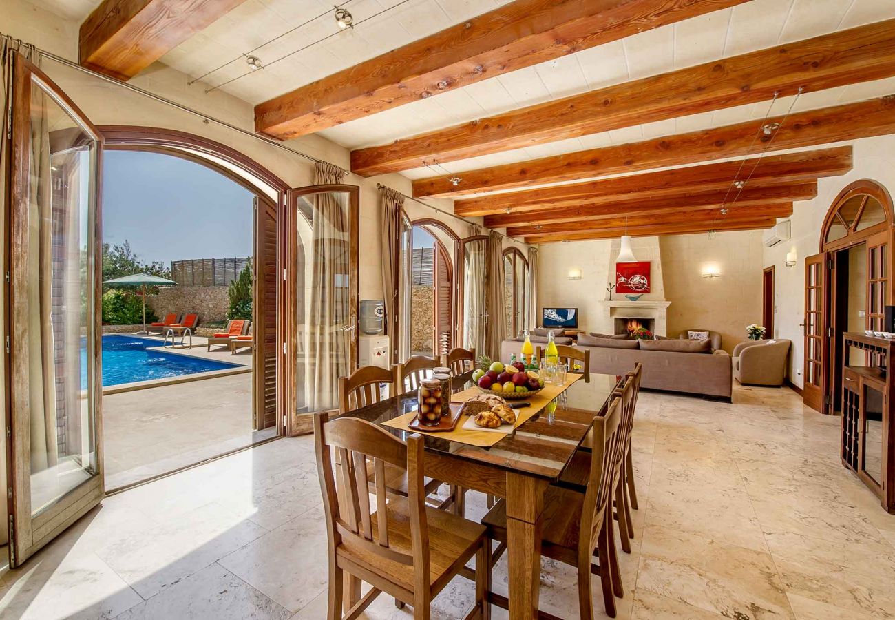 Gozo holiday villa dining area with wood-burning fireplace