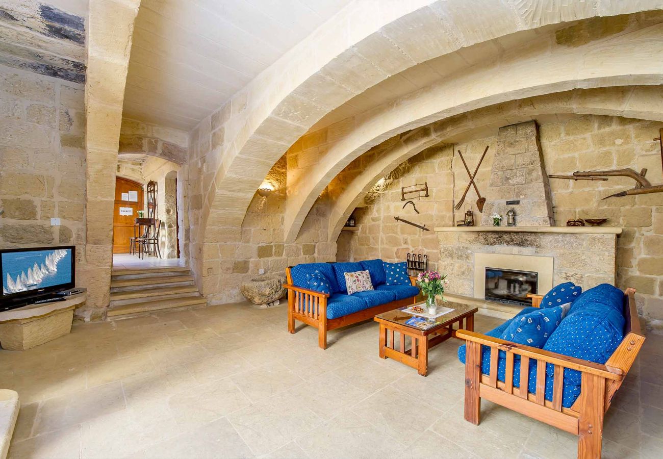 malta traditional farmhouse living area with fireplace